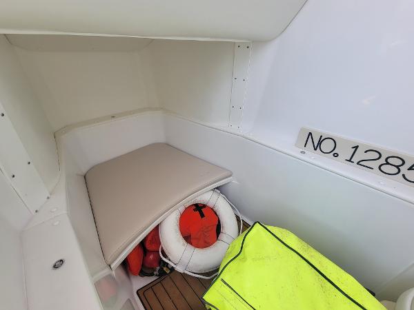 Slide: The Image of 2018 Spectre 35 Center Console by Pilini interior storage with life jackets and safety equipment. - 17