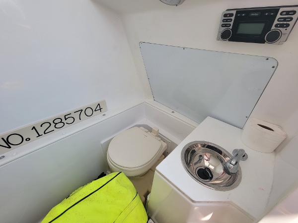 Slide: The Image of 2018 Spectre 35 Center Console by Pilini boat interior with toilet and sink. - 18