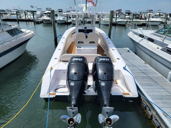 Slide: The Image of 2018 Spectre 35 Center Console by Pilini docked, featuring twin 350 horsepower engines. - 2