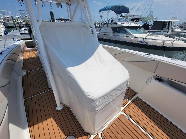 Slide: The Image of 2018 Spectre 35 Center Console by Pilini, docked, with covered helm and teak flooring. - 20