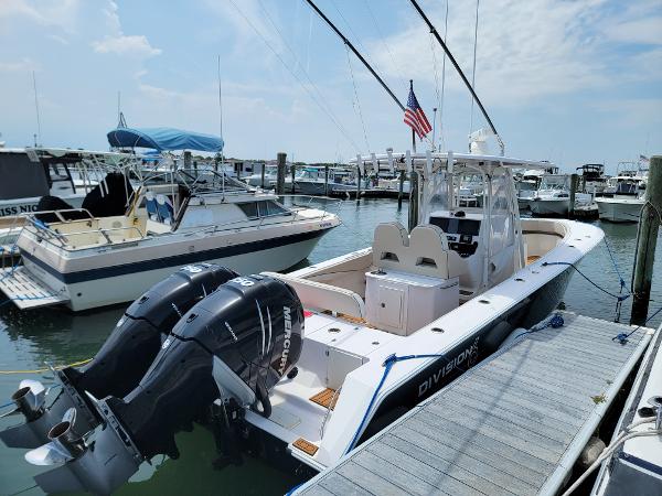 Slide: The Image of 2018 Spectre 35 Center Console by Pilini docked at marina with twin Mercury outboard engines. - 3