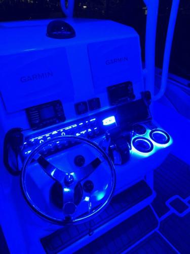 Slide: The Image of 2018 Spectre 35 Center Console by Pilini, illuminated boat dashboard with Garmin electronics. - 5