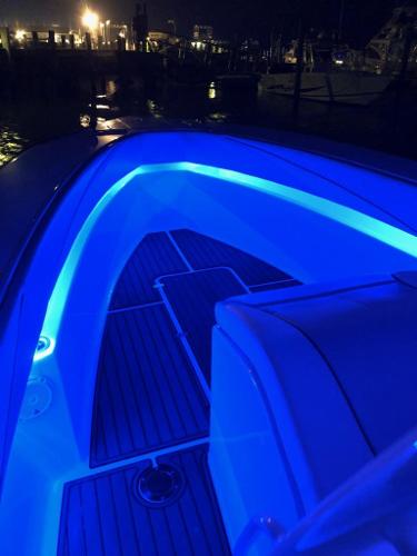 Slide: The Image of 2018 Spectre 35 Center Console by Pilini with blue LED deck lighting at night. - 6