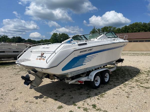 Slide: The Image of 1995 Sport-Craft 2500 AVANZA boat on a trailer in a gravel lot. - 3