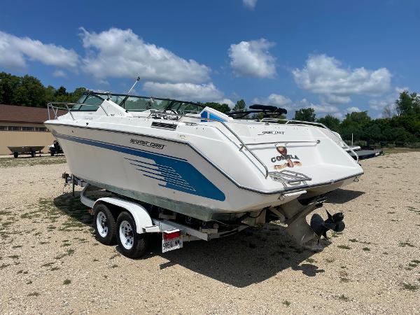 Slide: The Image of 1995 Sport-Craft 2500 AVANZA boat on a trailer in a sunny outdoor setting. - 4
