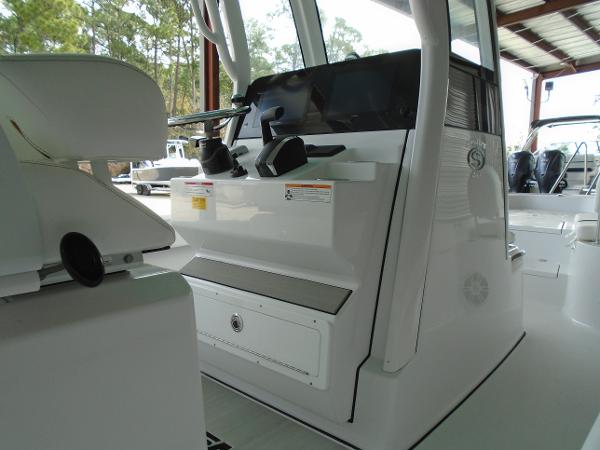Slide: The Image of 2024 Sportsman 267 boat console and seating area in a covered dock. - 12