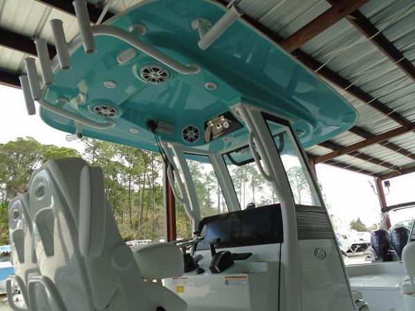 Slide: The Image of 2024 Sportsman 267 boat interior with teal roof and white seats. - 13