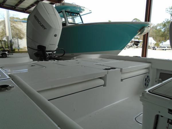 Slide: The Image of 2024 Sportsman 267 boat with Mercury outboard engine in a covered storage area. - 14