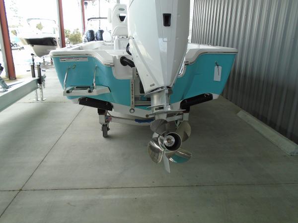 Slide: The Image of 2024 Sportsman 267 boat with outboard motor, teal and white color, rear view. - 9