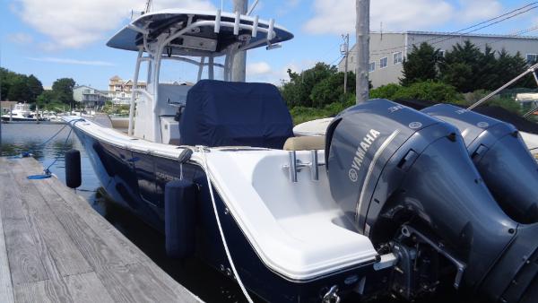 Slide: The Image of 2017 Sportsman 312 Open boat docked, featuring dual Yamaha engines. - 1