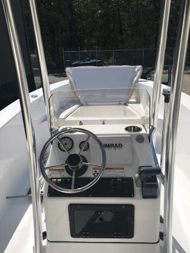 Slide: The Image of 2018 Sportsman Island Reef 19 Center Console boat interior with steering wheel and controls. - 1