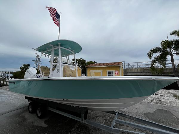 Slide: The Image of 2024 Sportsman Masters 227 Bay Boat on trailer with American flag. - 1