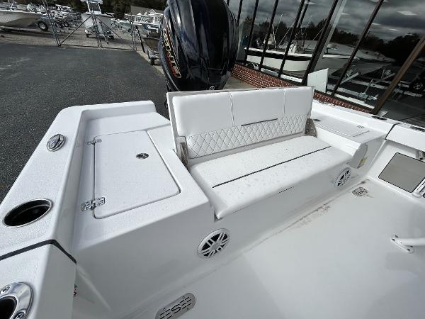 Slide: The Image of 2024 Sportsman Masters 227 Bay Boat with white seating and storage compartments. - 13