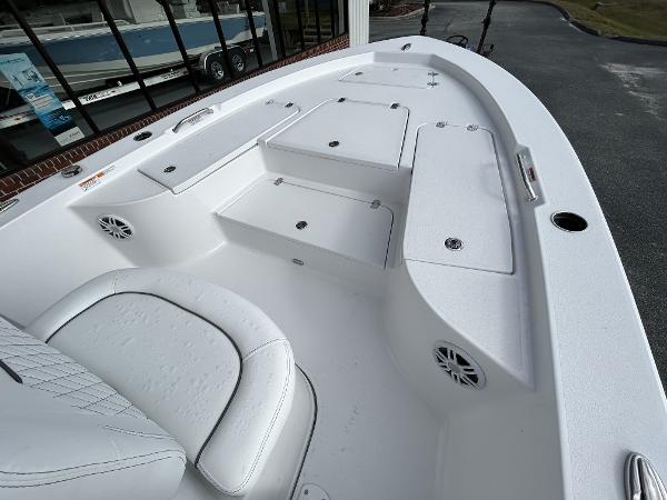 Slide: The Image of 2024 Sportsman Masters 227 Bay Boat interior with storage compartments and seating. - 18