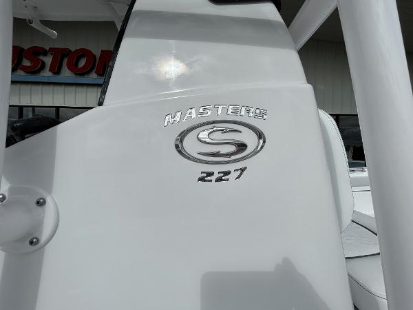 Slide: The Image of 2024 Sportsman Masters 227 Bay Boat logo on white surface. - 6