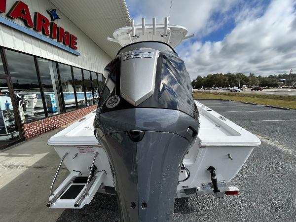 Slide: The Image of 2024 Sportsman Masters 227 Bay Boat rear view at a dealership. - 7
