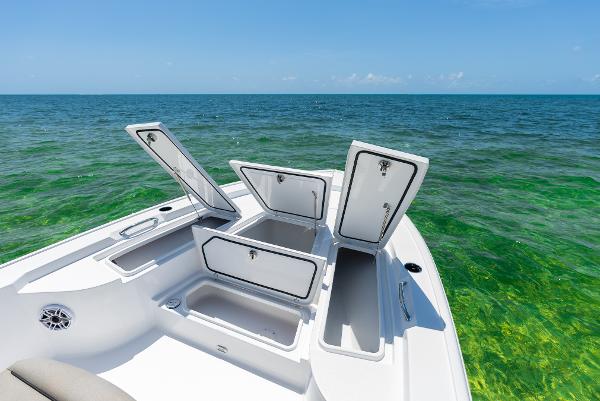 Slide: The Image of 2024 Sportsman Masters 247 Bay Boat with open storage compartments on the ocean. - 4