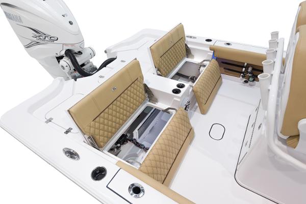 Slide: The Image of 2024 Sportsman Masters 267 Bay Boat interior with tan seating and storage compartments. - 10