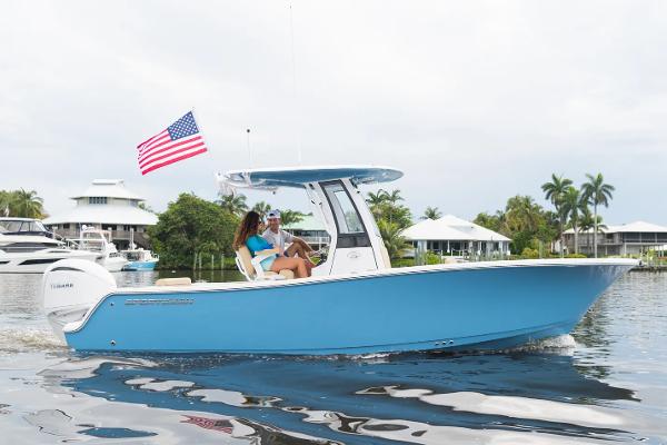 Slide: The Image of Manufacturer Provided Image: 2025 Sportsman Open 232 Center Console boat cruising on a calm waterway. - 0