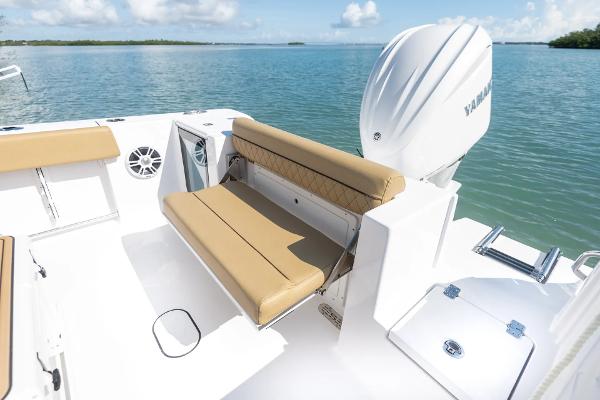 Slide: The Image of Manufacturer Provided Image: 2025 Sportsman Open 232 Center Console boat with tan seating, Yamaha engine, on calm water. - 10
