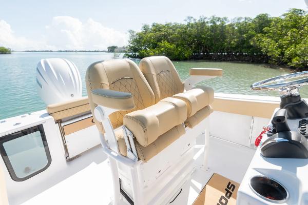 Slide: The Image of Manufacturer Provided Image: 2025 Sportsman Open 232 Center Console boat with tan seating, on a sunny day by the water. - 8