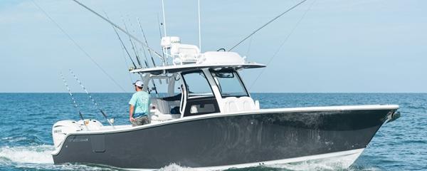 Slide: The Image of 2024 Sportsman Open 322 boat cruising on the ocean. - 0
