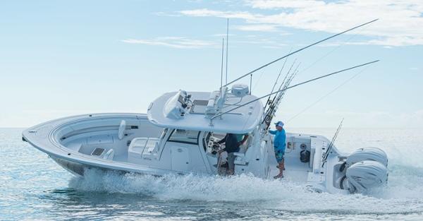 Slide: The Image of 2024 Sportsman Open 322 boat cruising on the water with fishing gear. - 2