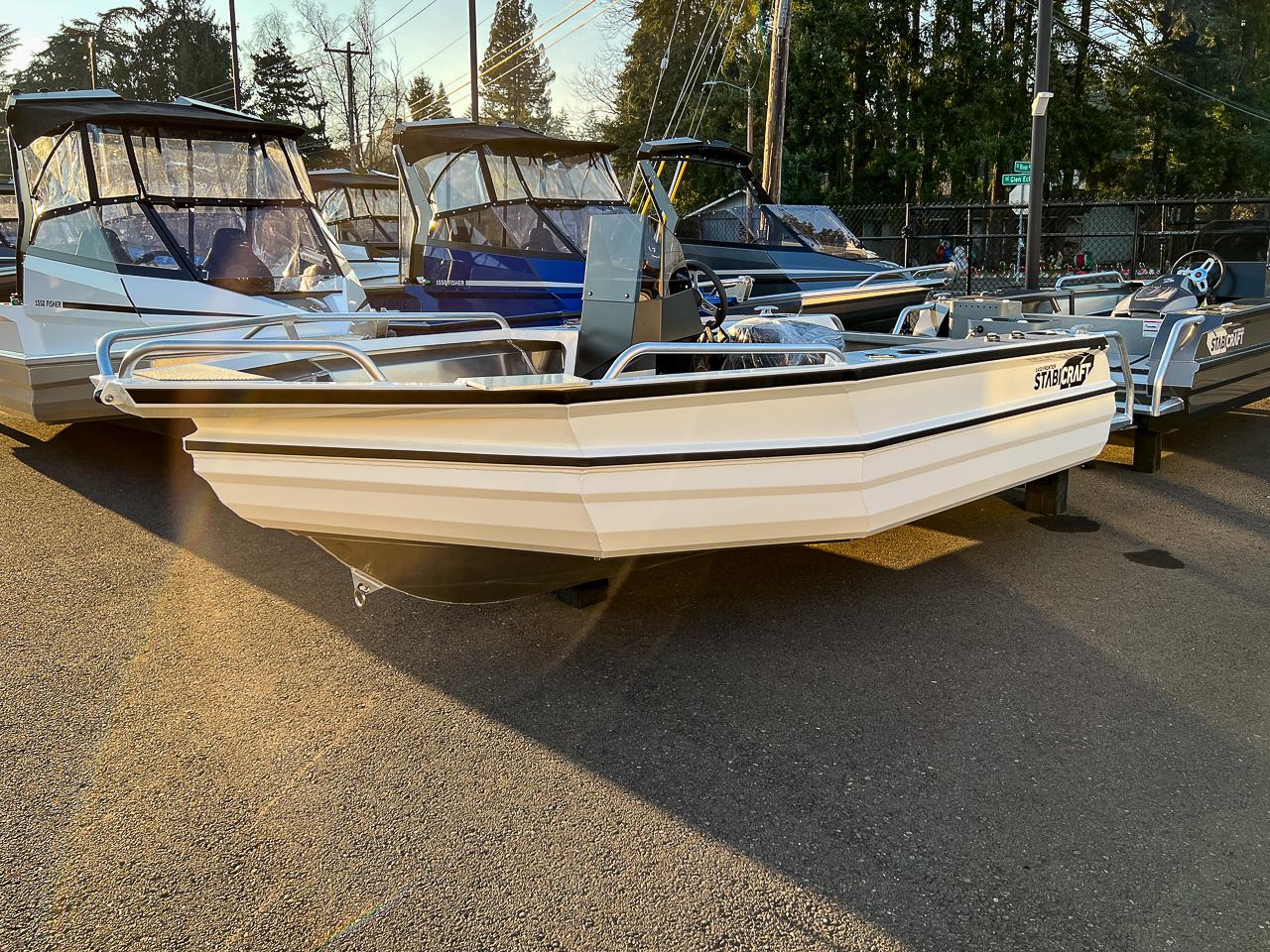 Slide: The Image of 2025 Stabicraft 1450 Frontier Profish boat displayed outdoors in a dealership lot. - 1