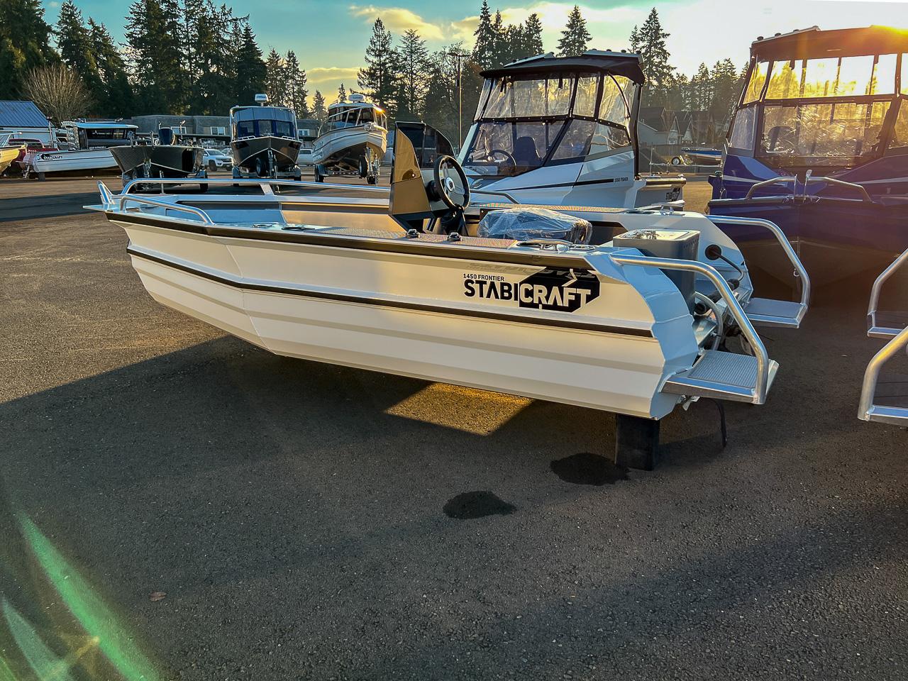 Slide: The Image of 2025 Stabicraft 1450 Frontier Profish boat displayed in a marina. - 2