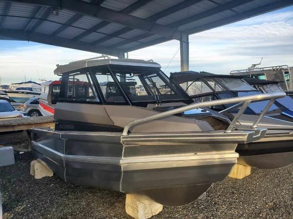 Slide: The Image of 2024 Stabicraft 1850 Supercab Adventure boat under a covered dock. - 3
