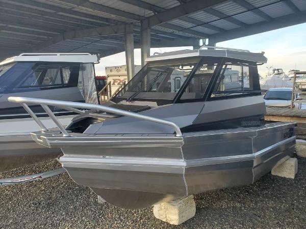 Slide: The Image of 2024 Stabicraft 1850 Supercab Adventure boat under a covered storage area. - 4