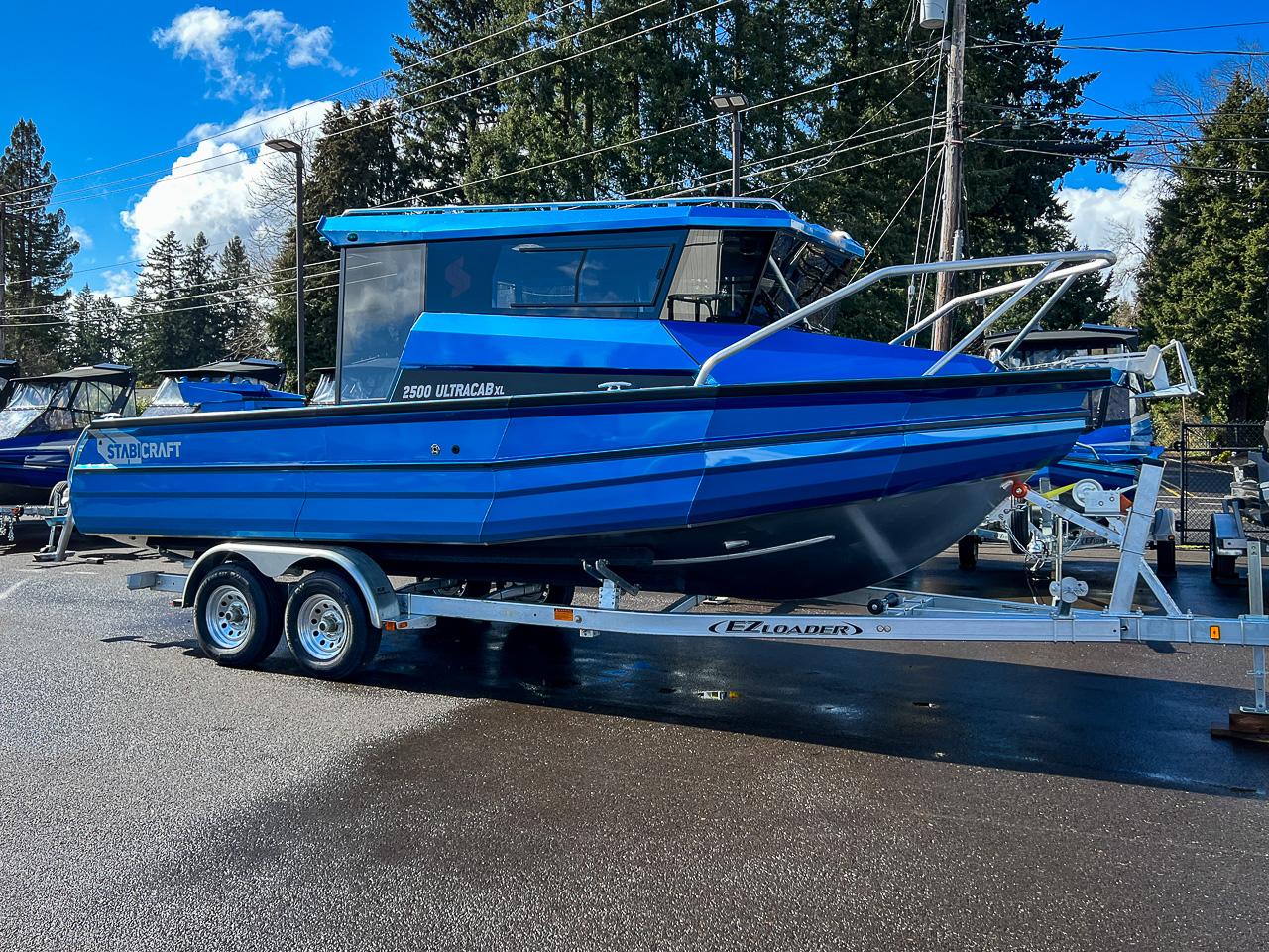Slide: The Image of 2023 Stabicraft 2500 Ultracab XL boat on a trailer in a parking lot. - 1