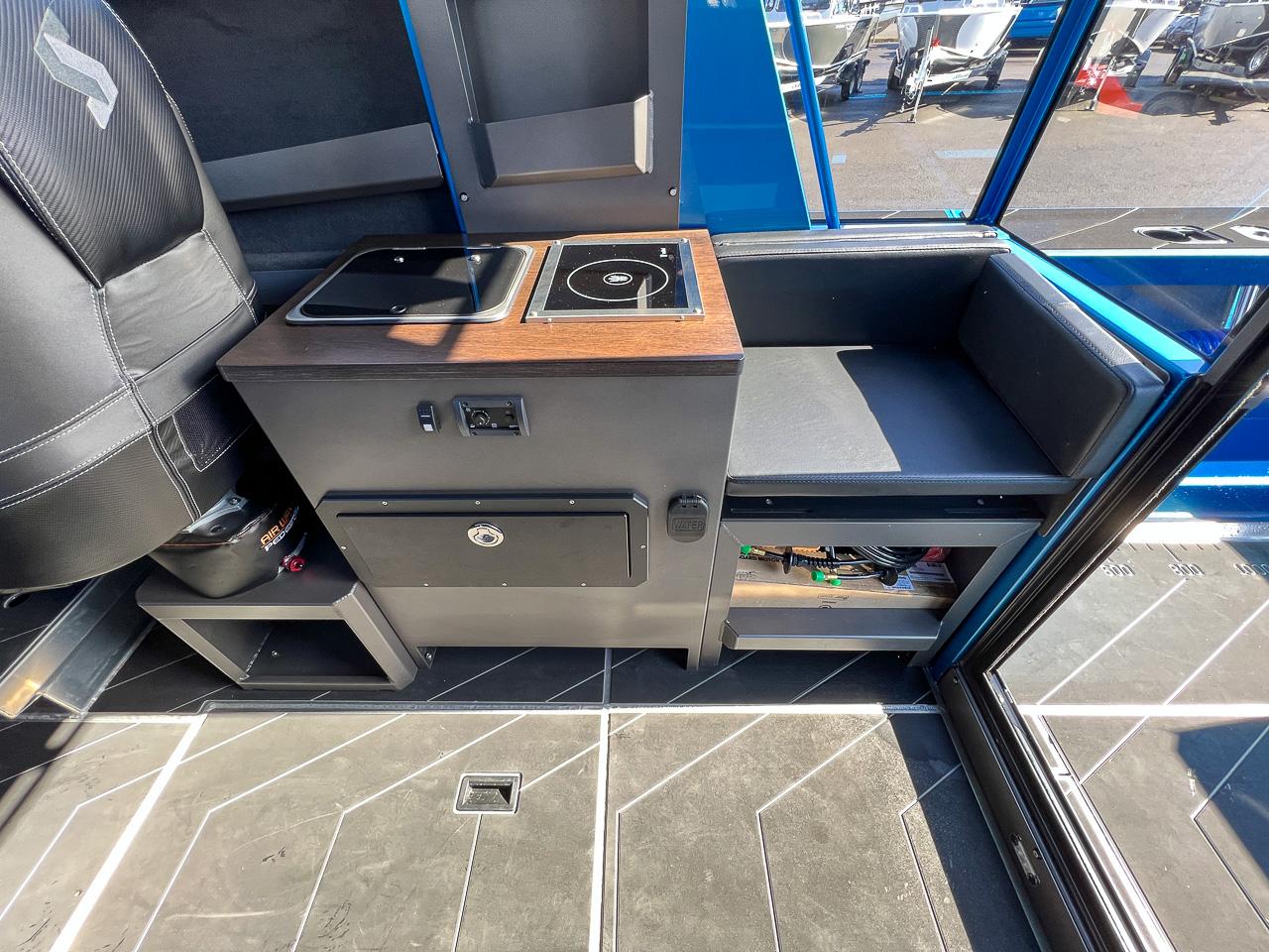 Slide: The Image of Interior of 2023 Stabicraft 2500 Ultracab XL featuring a compact kitchen area. - 15