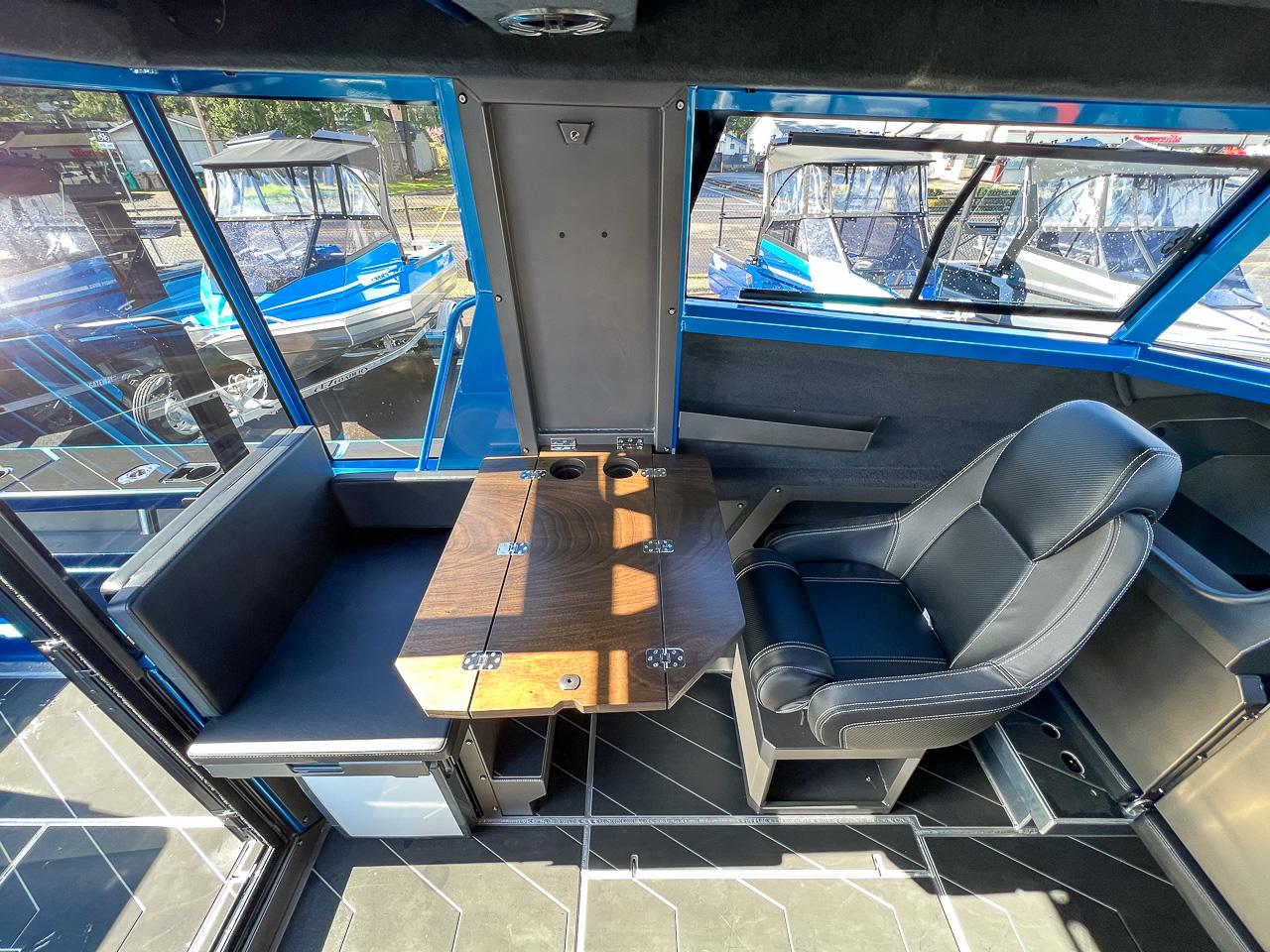 Slide: The Image of Interior of 2023 Stabicraft 2500 Ultracab XL with seating and table. - 17