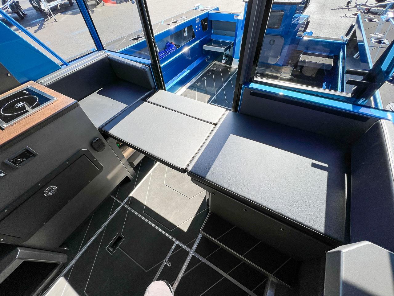 Slide: The Image of Interior of 2023 Stabicraft 2500 Ultracab XL with seating and table. - 18