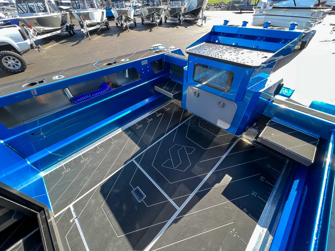 Slide: The Image of 2023 Stabicraft 2500 Ultracab XL boat interior with blue accents and storage compartments. - 21