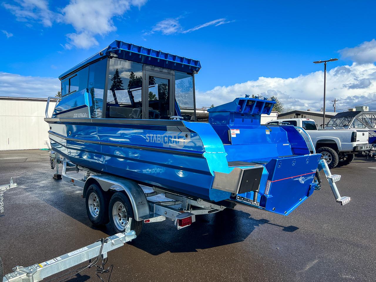 Slide: The Image of 2023 Stabicraft 2500 Ultracab XL boat in blue, parked on a trailer. - 5