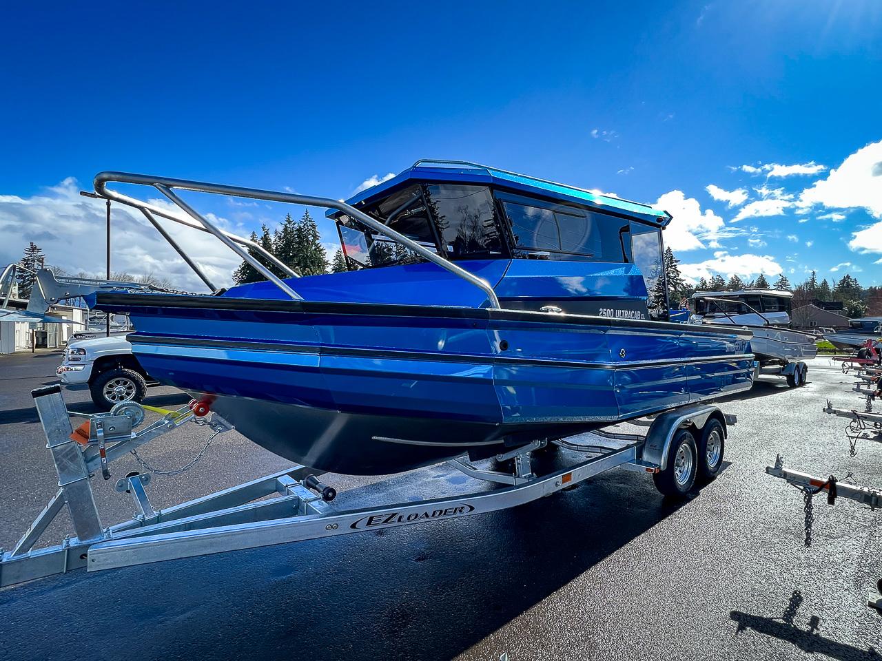 Slide: The Image of 2023 Stabicraft 2500 Ultracab XL boat on trailer under clear blue sky. - 6