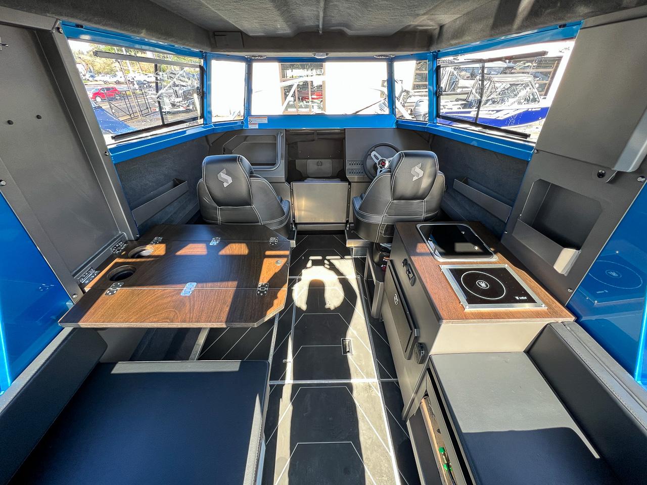 Slide: The Image of Interior of 2023 Stabicraft 2500 Ultracab XL, featuring seating, table, and kitchenette. - 7