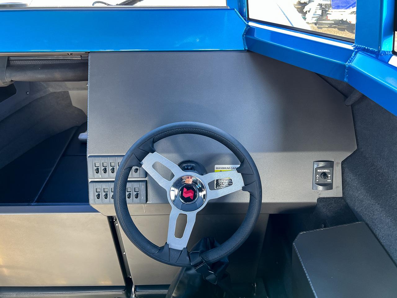 Slide: The Image of 2023 Stabicraft 2500 Ultracab XL helm with steering wheel and control panel. - 9