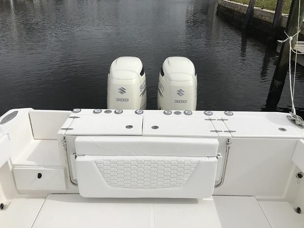 Slide: The Image of 2023 Stamas 31T Aventura boat with dual Suzuki outboard engines on a calm waterway. - 11