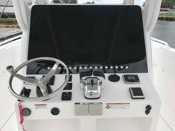 Slide: The Image of 2023 Stamas 31T Aventura boat dashboard with steering wheel and controls. - 3