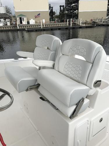 Slide: The Image of 2023 Stamas 31T Aventura boat with luxurious white seating by the dock. - 4