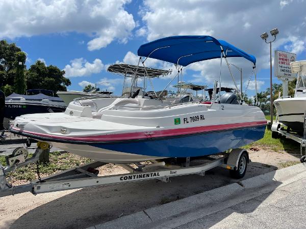 Slide: The Image of 2018 Starcraft 2000 OB Limited boat on a Continental trailer with blue canopy. - 1