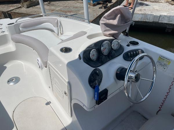 Slide: The Image of 2018 Starcraft 2000 OB Limited boat dashboard and seating area. - 13