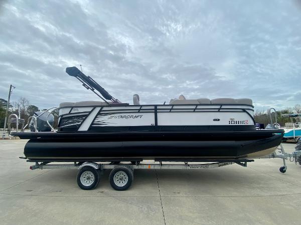Slide: The Image of 2023 Starcraft SLS 3 pontoon boat on a trailer. - 0