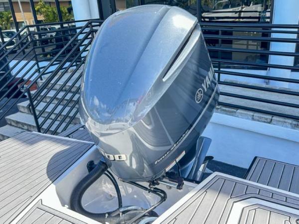 Slide: The Image of 2024 Starcraft SVX 231 OB DH with Yamaha outboard motor, docked on a sunny day. - 12
