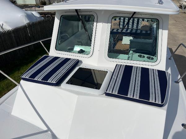 Slide: The Image of 2025 Steiger Craft 255 Annapolis boat with striped cushions on deck. - 40