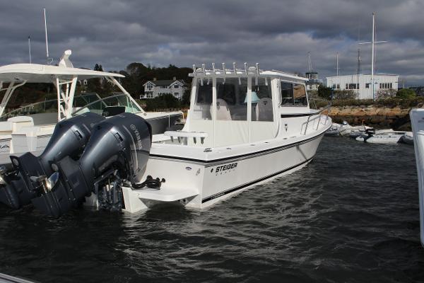 Slide: The Image of 2024 Steiger Craft 31 Miami boat docked with twin outboard engines. - 1