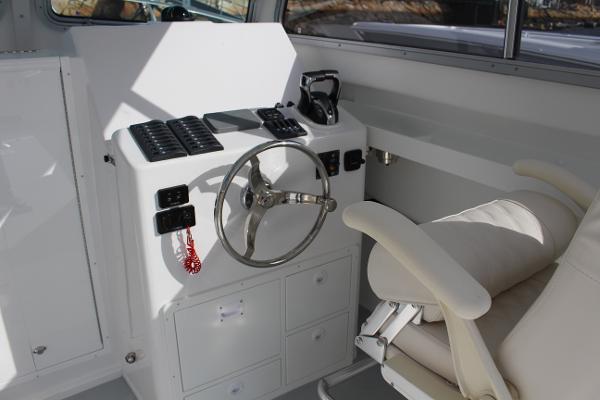 Slide: The Image of Steiger Craft 31 Miami 2024 helm station with steering wheel and captain's chair. - 16